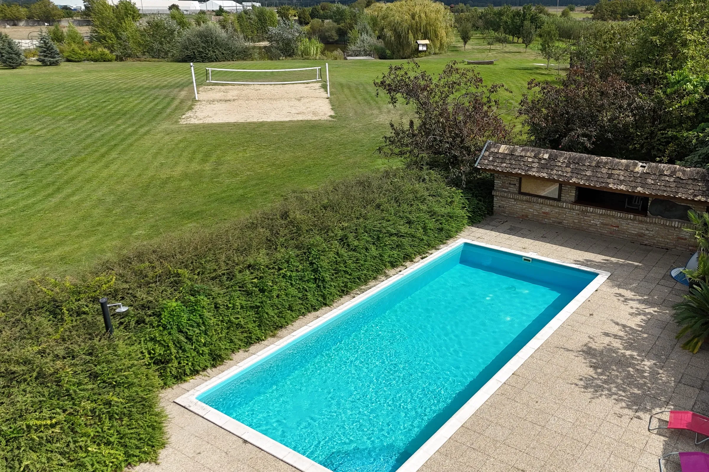 Outdoor pool with a paved terrace in the park
