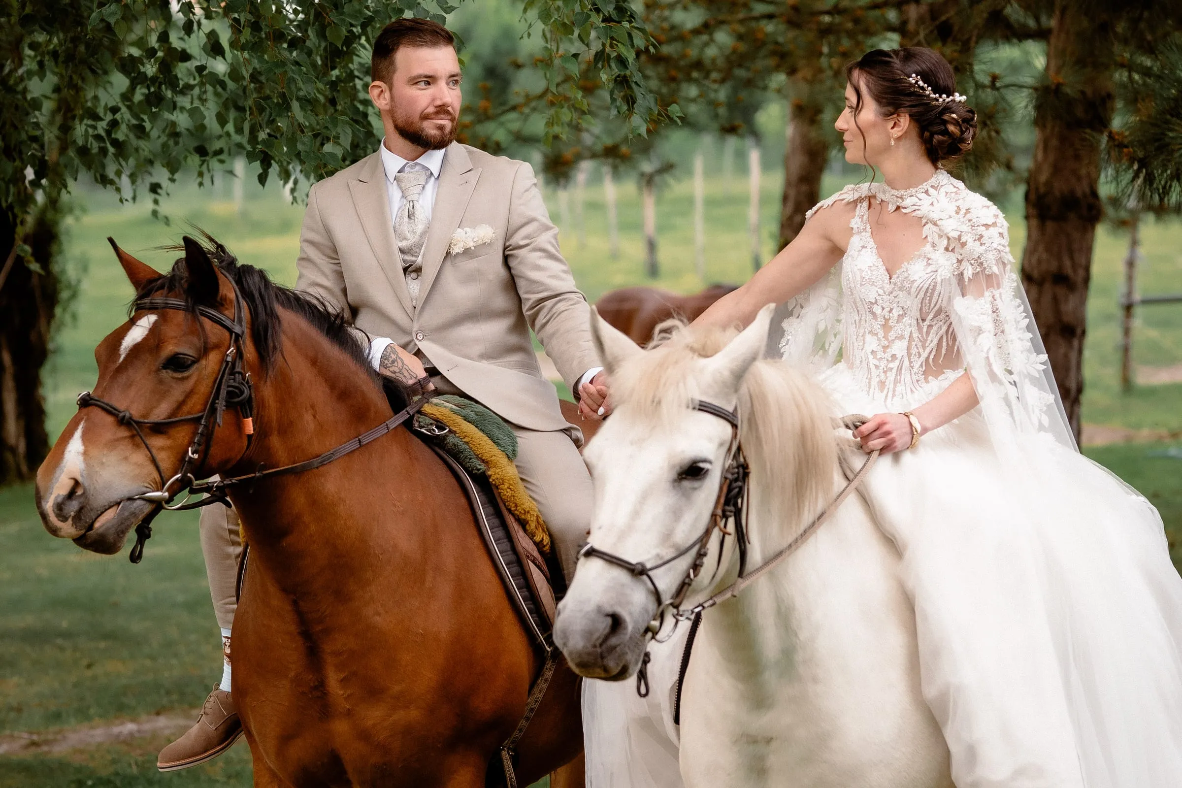 Bride and groom on horseback in the park
