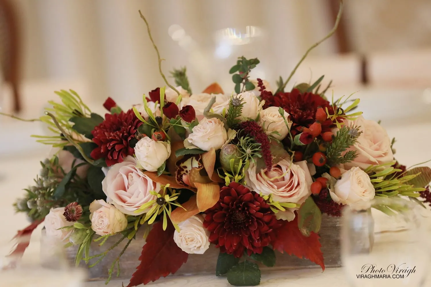 Burgundy floral arrangement on the table