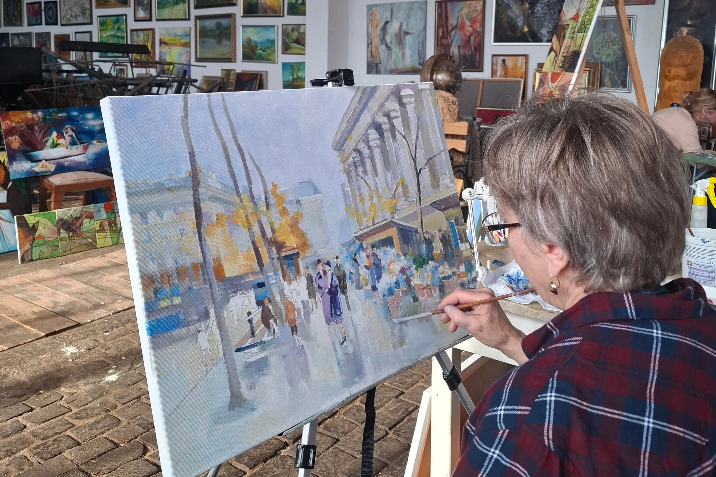 Painter at her canvas during an open-air painting session in the grounds